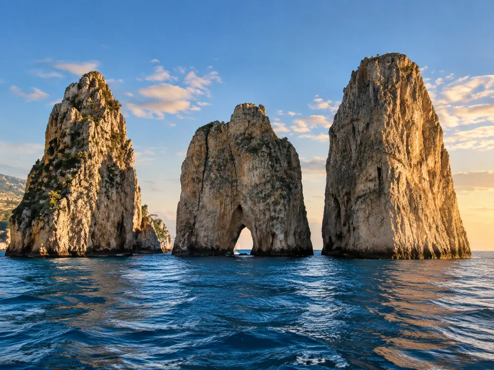 Tour boats off the Capri coast near the faraglioni rocks